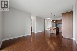 Unfurnished living room featuring dark wood finished floors and recessed lighting - 