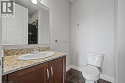 Full bath featuring marble look tiles, vanity, and a tile shower - 