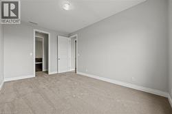 Unfurnished bedroom featuring baseboards and carpet flooring - 