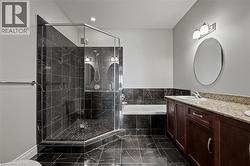 Full bath with a bath, double vanity, marble finish flooring, a stall shower, and recessed lighting - 