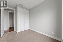 Unfurnished bedroom featuring carpet flooring and a closet - 