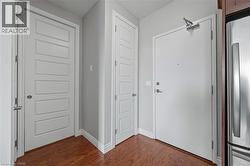 Foyer with dark wood finished floors and baseboards - 
