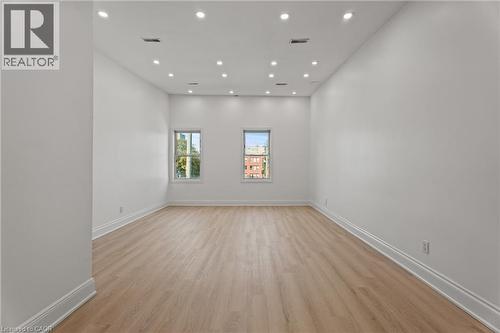 Unfurnished room featuring light wood-style flooring and recessed lighting - 93 John Street S, Hamilton, ON 