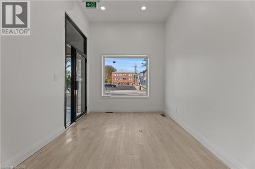 Empty room featuring light wood-type flooring and recessed lighting - 93 John Street S, Hamilton, ON 
