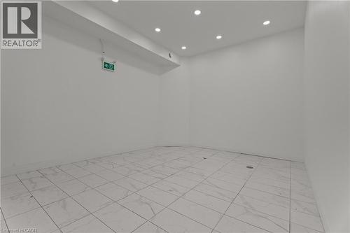 Empty room with recessed lighting - 93 John Street S, Hamilton, ON 
