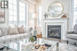 Living area with a glass covered fireplace and wood finished floors - 