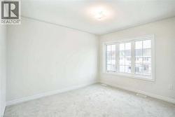 Carpeted empty room with baseboards and visible vents - 