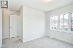 Carpeted spare room with baseboards - 