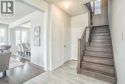 Staircase with a textured ceiling, baseboards, and wood finished floors - 