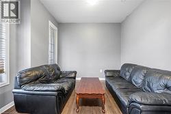 Living room featuring wood finished floors and a textured ceiling - 