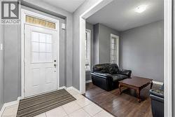 Entryway with light tile patterned floors and a textured ceiling - 