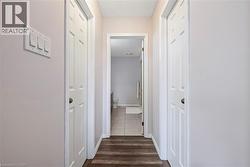Hallway featuring dark wood-style floors - 