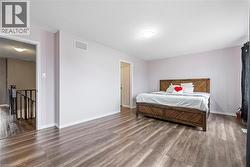 Bedroom featuring wood finished floors and a textured ceiling - 