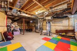 Unfinished below grade area with gas water heater and heating unit - 