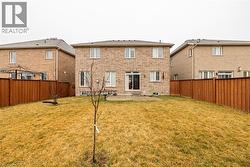 Back of house with a patio, brick siding, and a fenced backyard - 