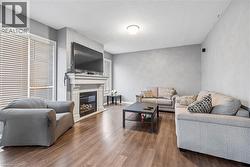 Living area featuring a fireplace, wood finished floors, and a textured ceiling - 
