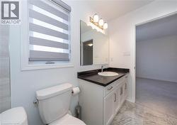 Half bathroom featuring vanity and light colored carpet - 