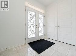 Foyer featuring french doors and baseboards - 