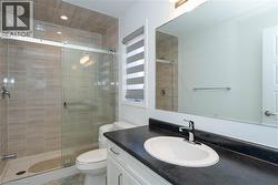 Full bathroom featuring vanity and a stall shower - 