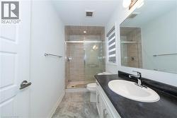 Full bath featuring a stall shower and vanity - 