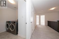 Washroom featuring washer and clothes dryer and baseboards - 