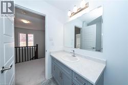 Bathroom with vanity and light carpet - 