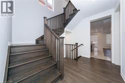 Staircase with wood finished floors and recessed lighting - 