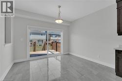 Unfurnished dining area with baseboards and a sunroom - 