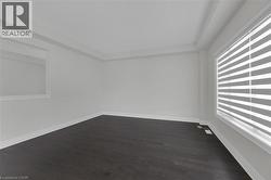 Spare room with dark wood-style floors - 