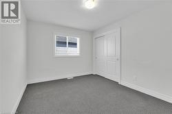 Unfurnished bedroom featuring carpet floors and a closet - 