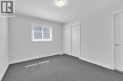 Unfurnished bedroom featuring carpet floors and a closet - 