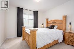 Bedroom featuring baseboards and light carpet - 