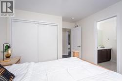 Bedroom with ensuite bath, visible vents, and a closet - 