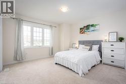 Bedroom featuring light colored carpet and baseboards - 