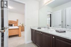 Ensuite bathroom with tile patterned flooring, vanity, and connected bathroom - 
