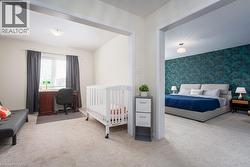 Bedroom with carpet floors and wallpapered walls - 