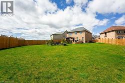 View of yard featuring a fenced backyard and a gazebo - 