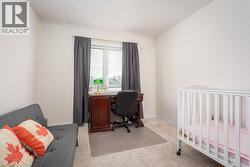 Carpeted bedroom featuring baseboards - 