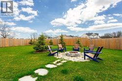 View of yard with a fire pit and a fenced backyard - 