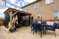 Wooden terrace with a gazebo, outdoor lounge area, and outdoor dining area - 