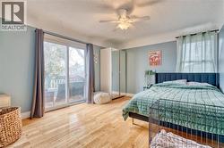 Bedroom with access to exterior, light hardwood / wood-style flooring, and ceiling fan - 