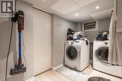 Laundry area with washer and clotdryer and light hardwood / wood-style floors - 