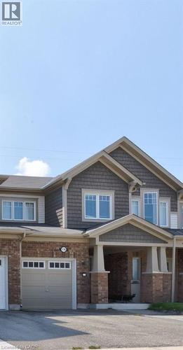 View of front of property featuring covered porch, brick siding, and asphalt driveway - 116 Watermill Street, Kitchener, ON - Outdoor With Facade