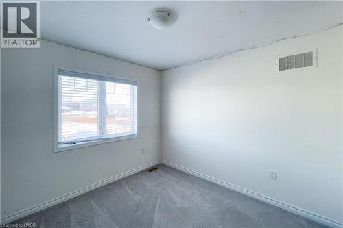 Empty room featuring carpet floors and baseboards - 116 Watermill Street, Kitchener, ON - Indoor Photo Showing Other Room