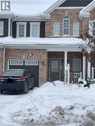 Traditional-style house with stone siding, a porch, and an attached garage - 128 Watermill Street, Kitchener, ON - Outdoor With Facade