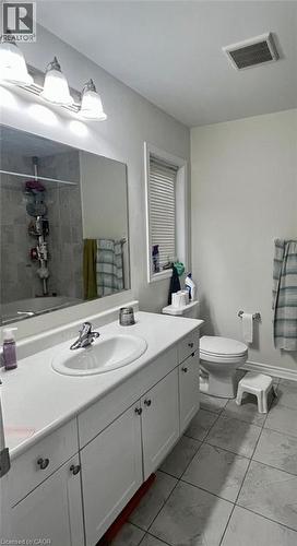 Bathroom featuring a shower with curtain, vanity, and light marble finish flooring - 128 Watermill Street, Kitchener, ON - Indoor Photo Showing Bathroom
