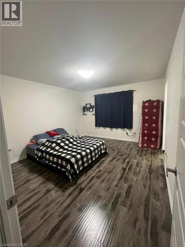 Bedroom with dark wood-type flooring and baseboards - 128 Watermill Street, Kitchener, ON - Indoor Photo Showing Bedroom