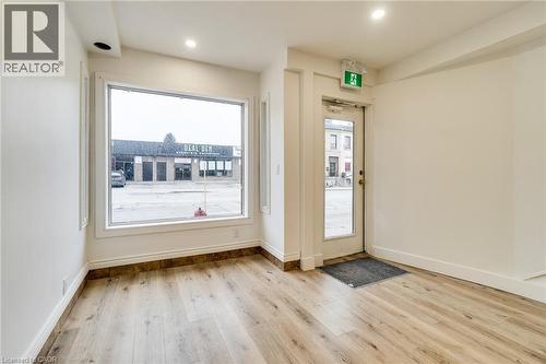 Doorway to outside featuring wood finished floors and baseboards - 18 Barton Street E Unit# A, Hamilton, ON 