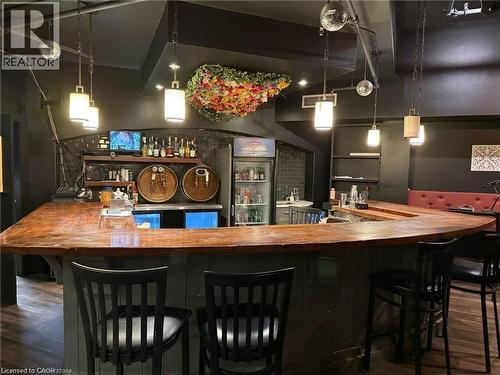 Indoor wet bar with pendant lighting, wood counters, and open shelves - 179 King Street W, Kitchener, ON 