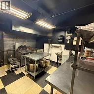 Kitchen with stainless steel range with gas stovetop and dark cabinetry - 